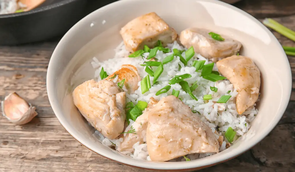 Delicious Marry Me Chicken served in a crockpot, garnished with fresh herbs and sun-dried tomatoes.